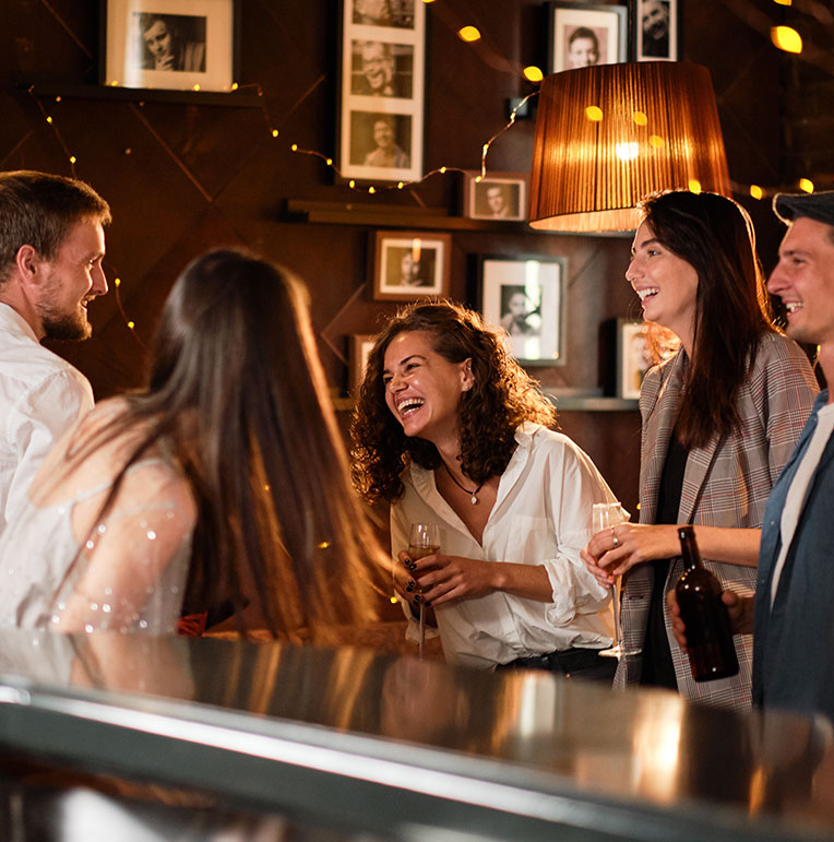 People enjoying a drink and a laugh at a singles event